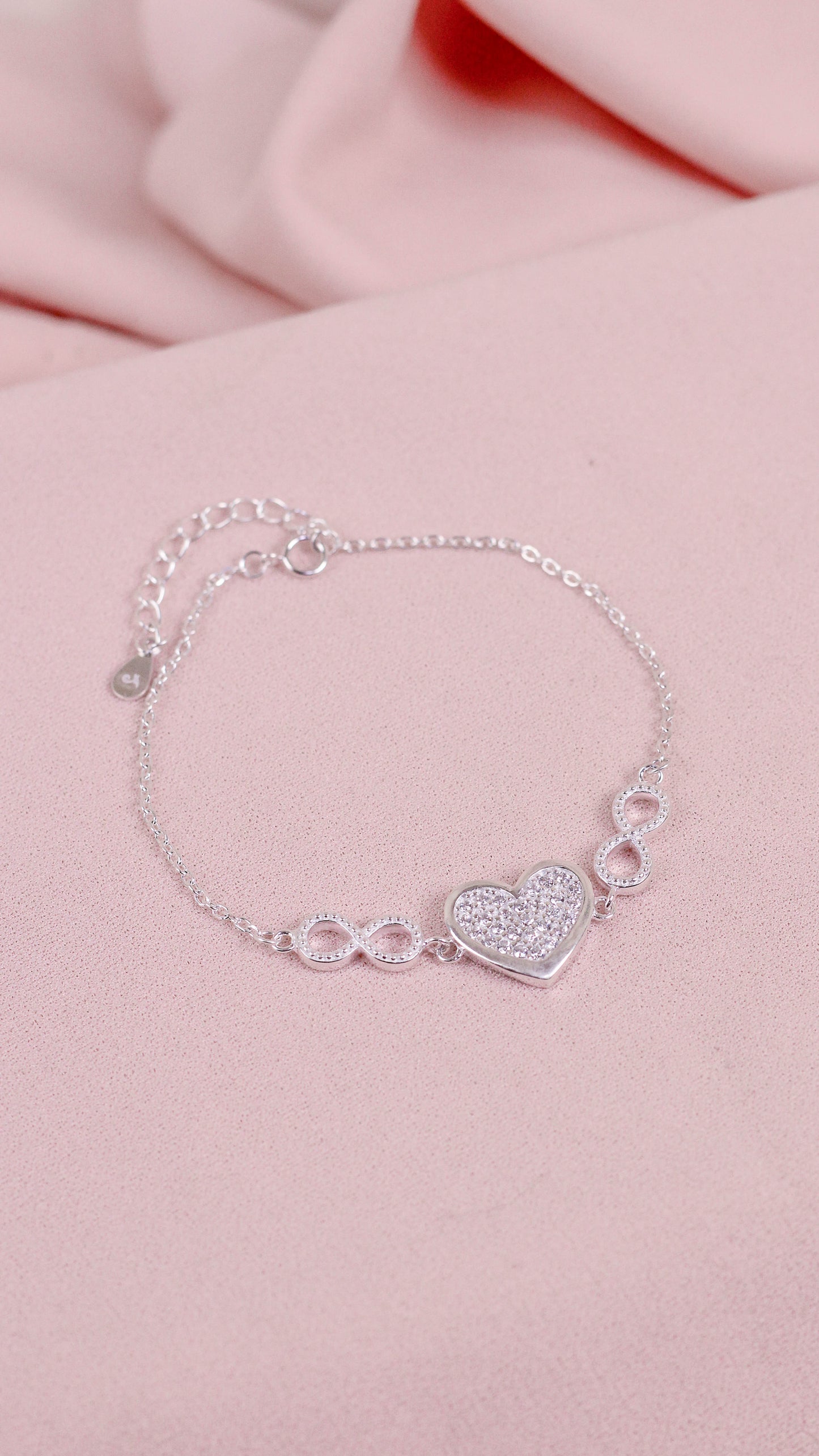Pulsera corazon con infinitos a los lados circones - Plata