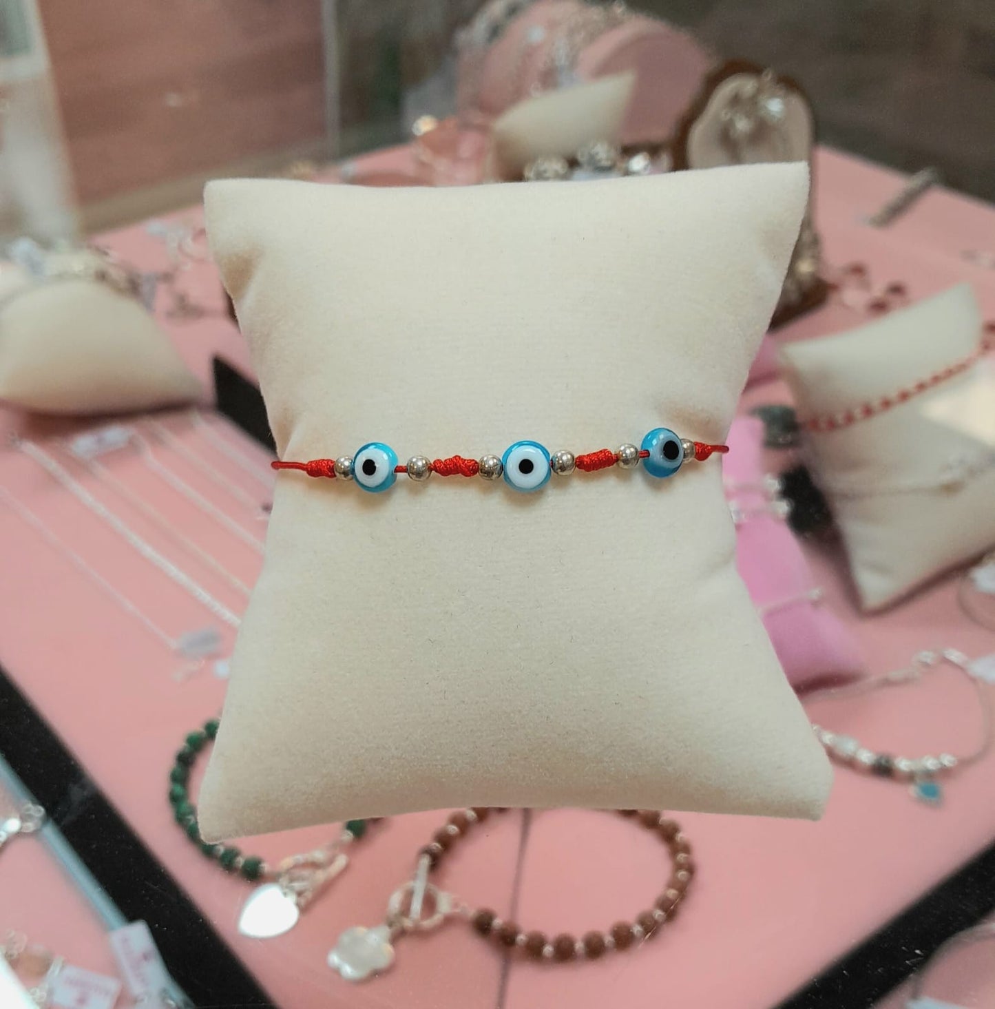 Pulsera ajustable ojos turcos celeste hilo rojo - Plata