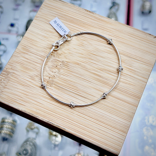 Pulsera tubos con shakiras entrelazadas - plata